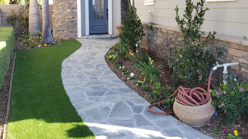 Updated front entry with synthetic turf and new planter plants in Brea