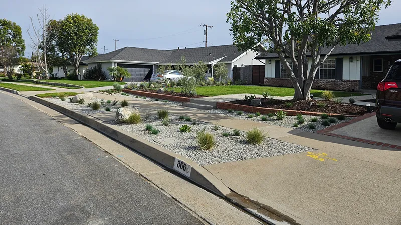 Finished xeriscape with drought-tolerant planting and decorative materials