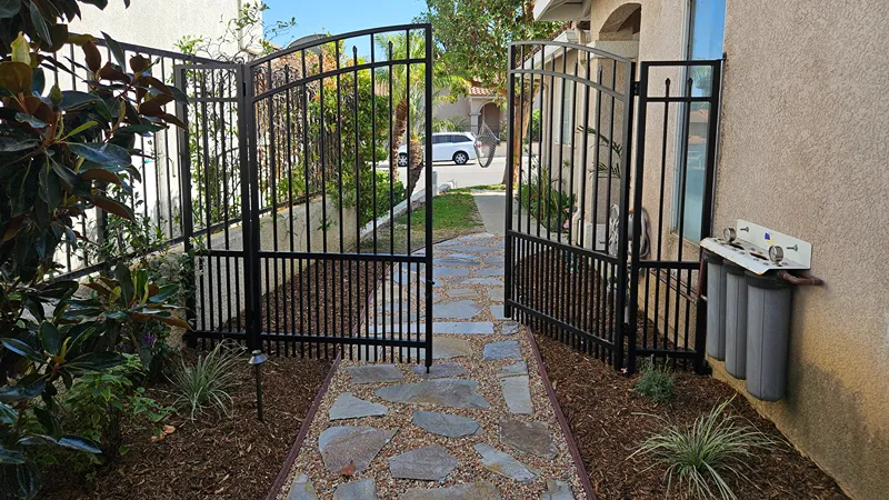 Renovated garden bed with new plants, defined edges, and ground covering