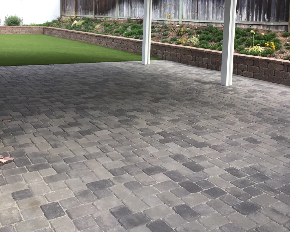 Paver patio installed beside a residential lawn area
