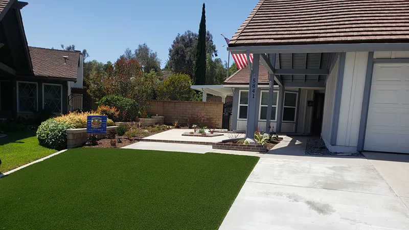 Updated front planting area with drought-tolerant plants and organic mulch